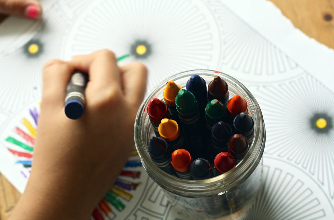 Hand coloring with crayons on paper